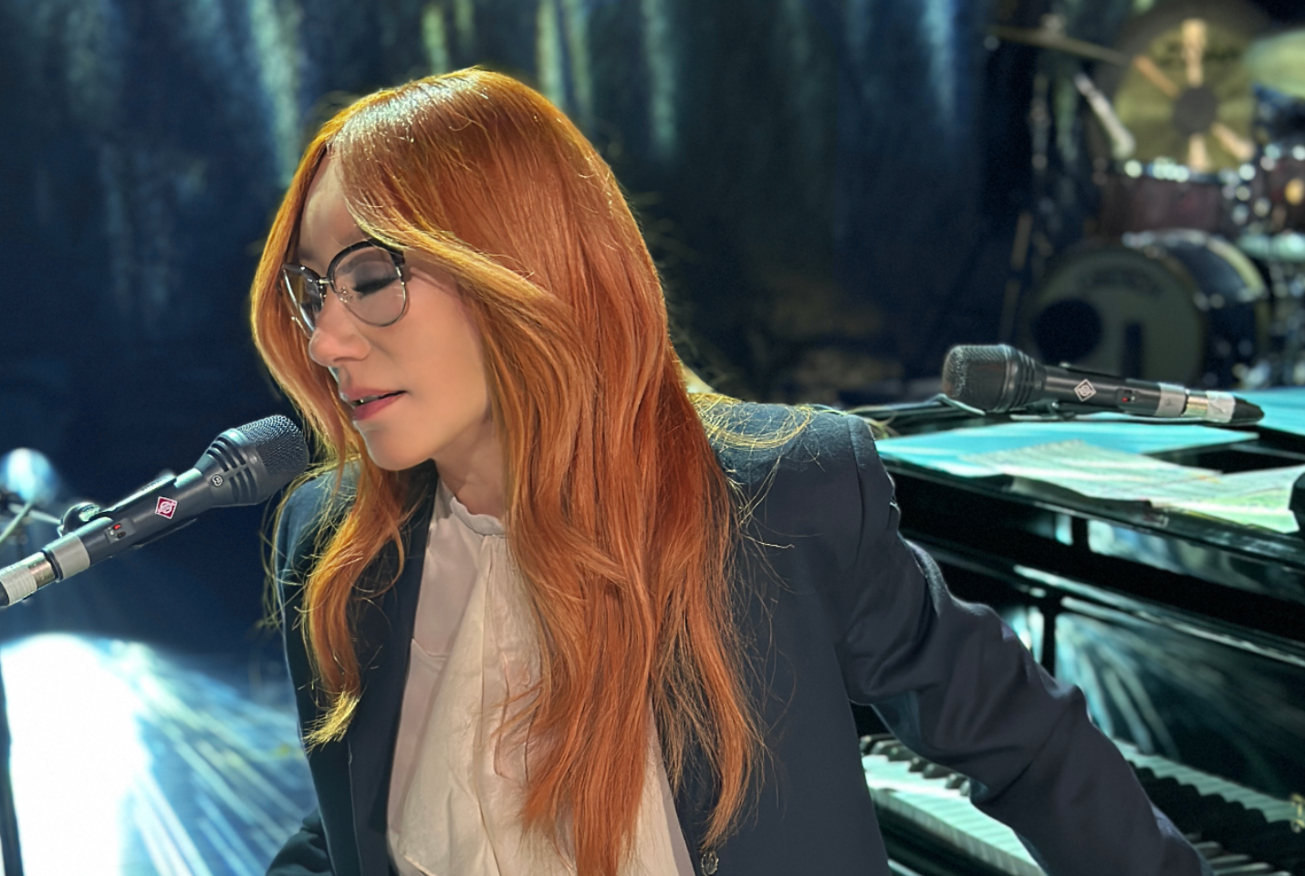 Artist Tori Amos singing on microphone